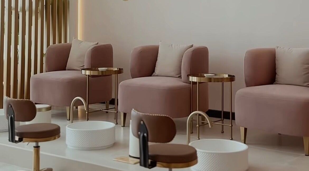 Chic pedicure lounge at Glowing Beauty & Spa, Al Athaiba, Muscat Governorate, OM, featuring plush seating.