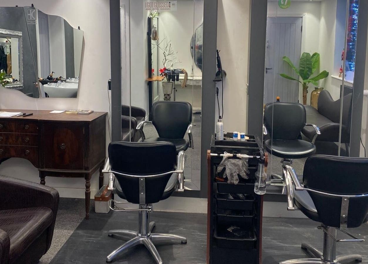 Modern styling area at DivaDazzle Hair Extensions in Denton, England, GB featuring sleek chairs and mirrors.