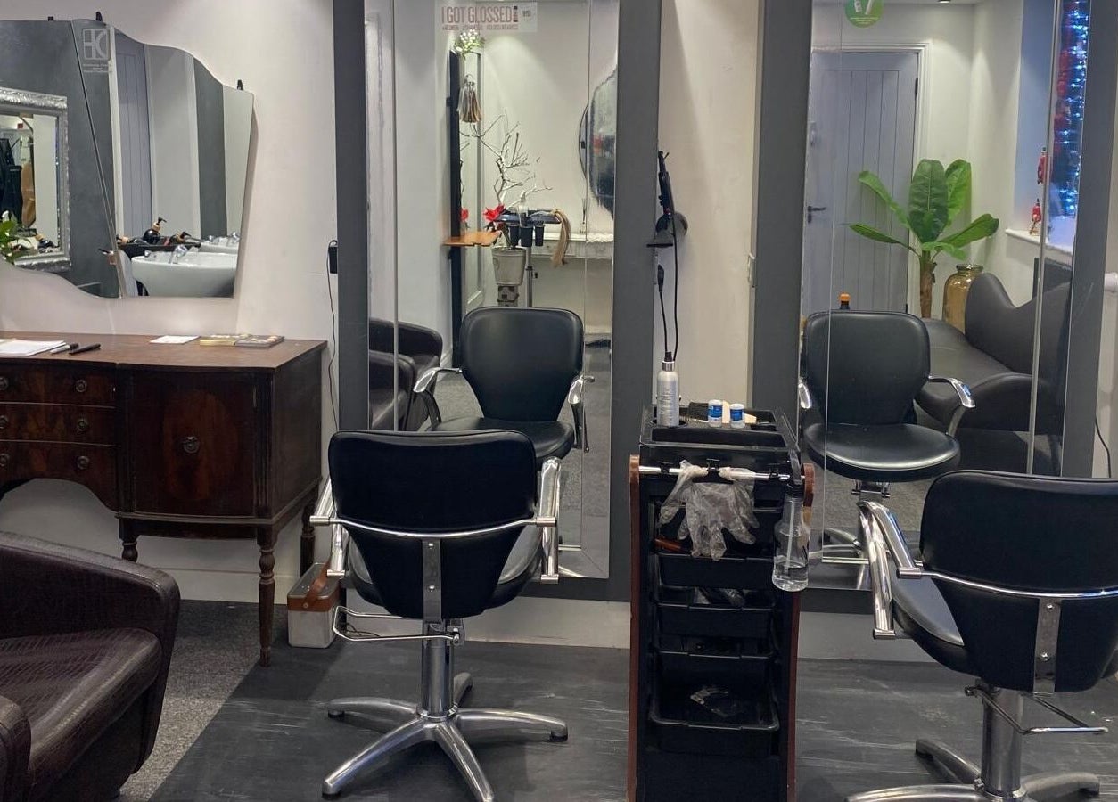 Modern styling area at DivaDazzle Hair Extensions in Denton, England, GB featuring sleek chairs and mirrors.