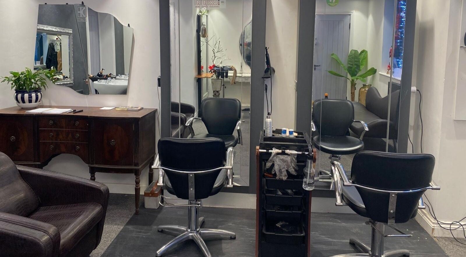 Modern styling area at DivaDazzle Hair Extensions in Denton, England, GB featuring sleek chairs and mirrors.