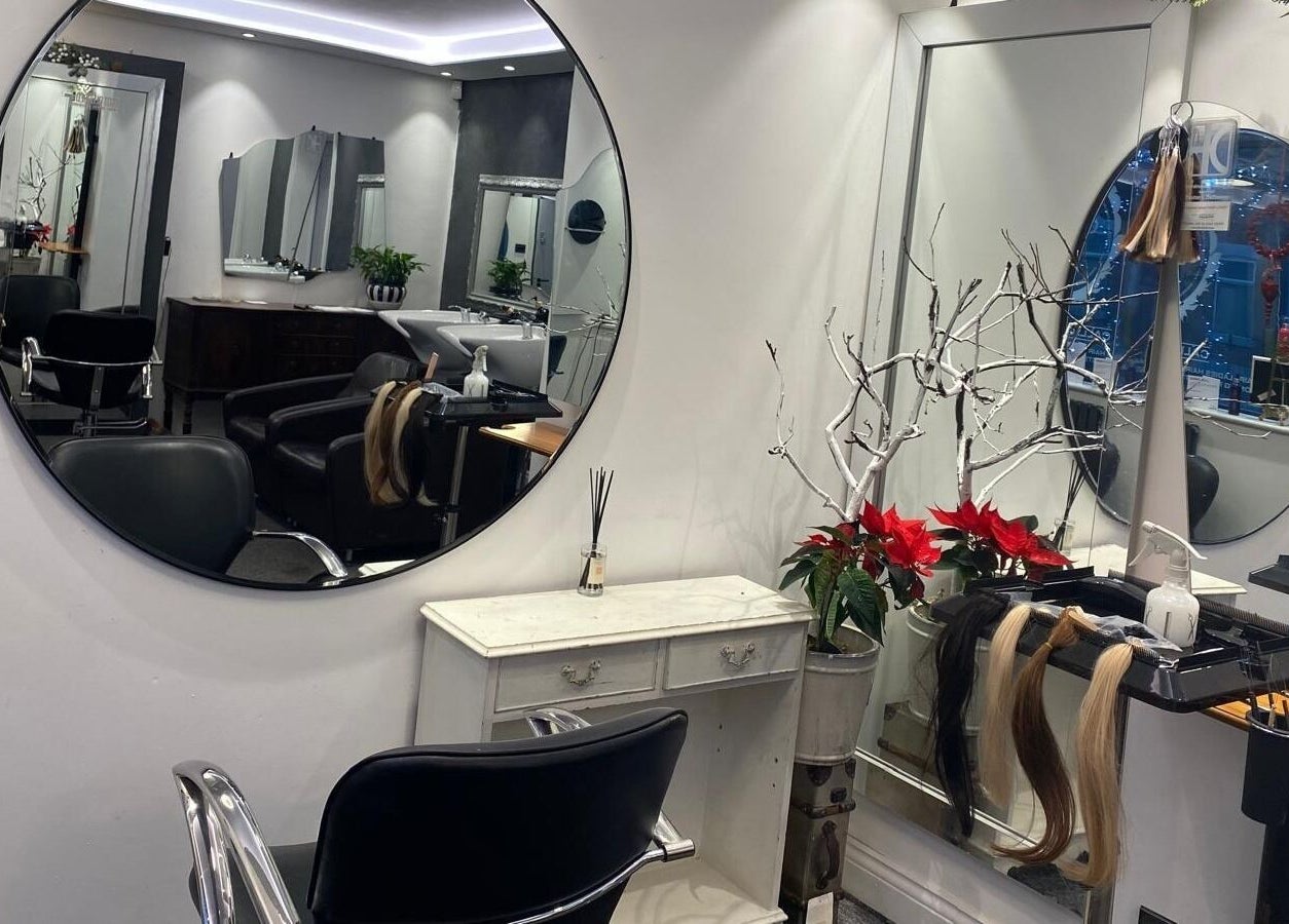 DivaDazzle Hair Extensions salon interior in Denton, England, showcasing styling mirrors and elegant decor.