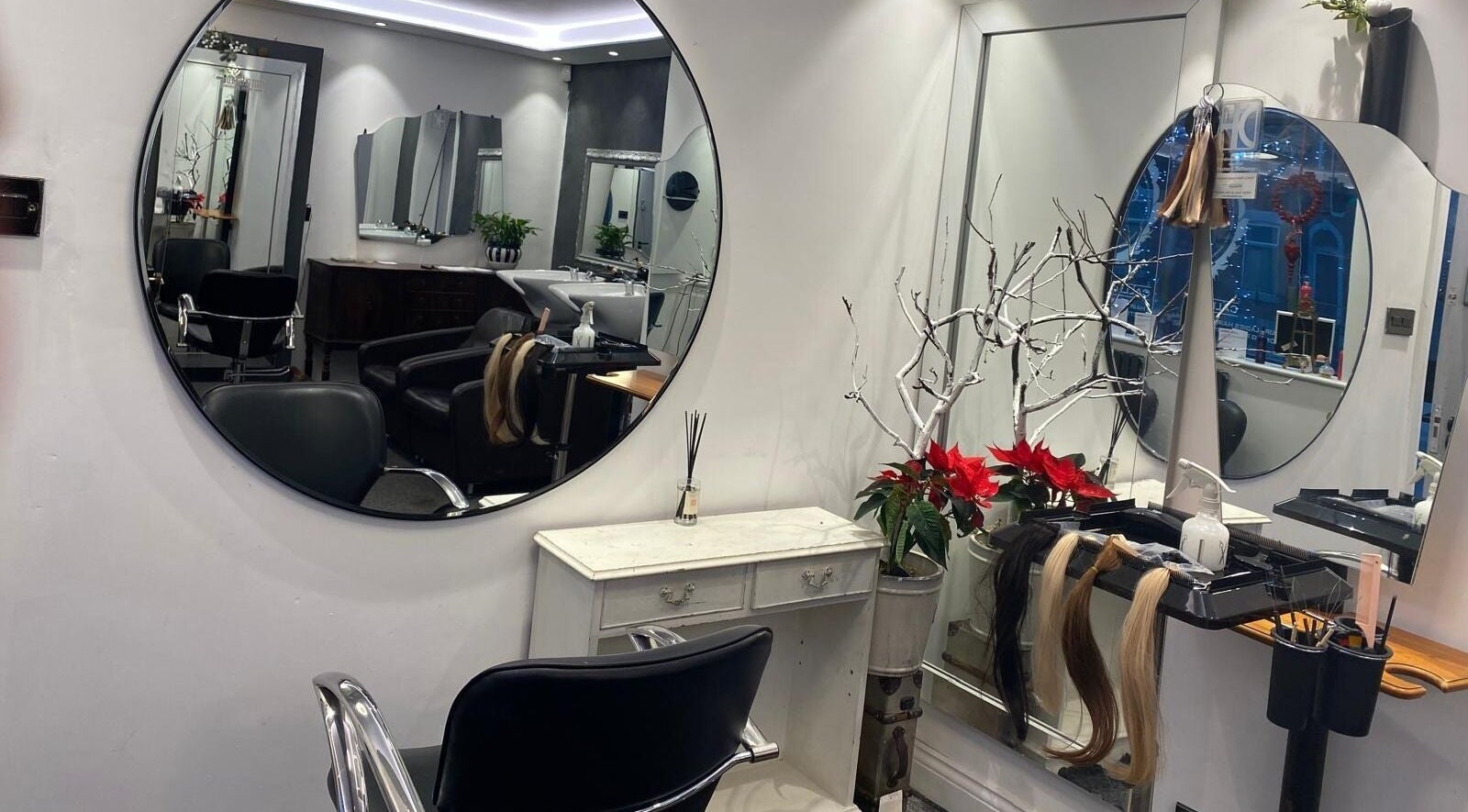 DivaDazzle Hair Extensions salon interior in Denton, England, showcasing styling mirrors and elegant decor.