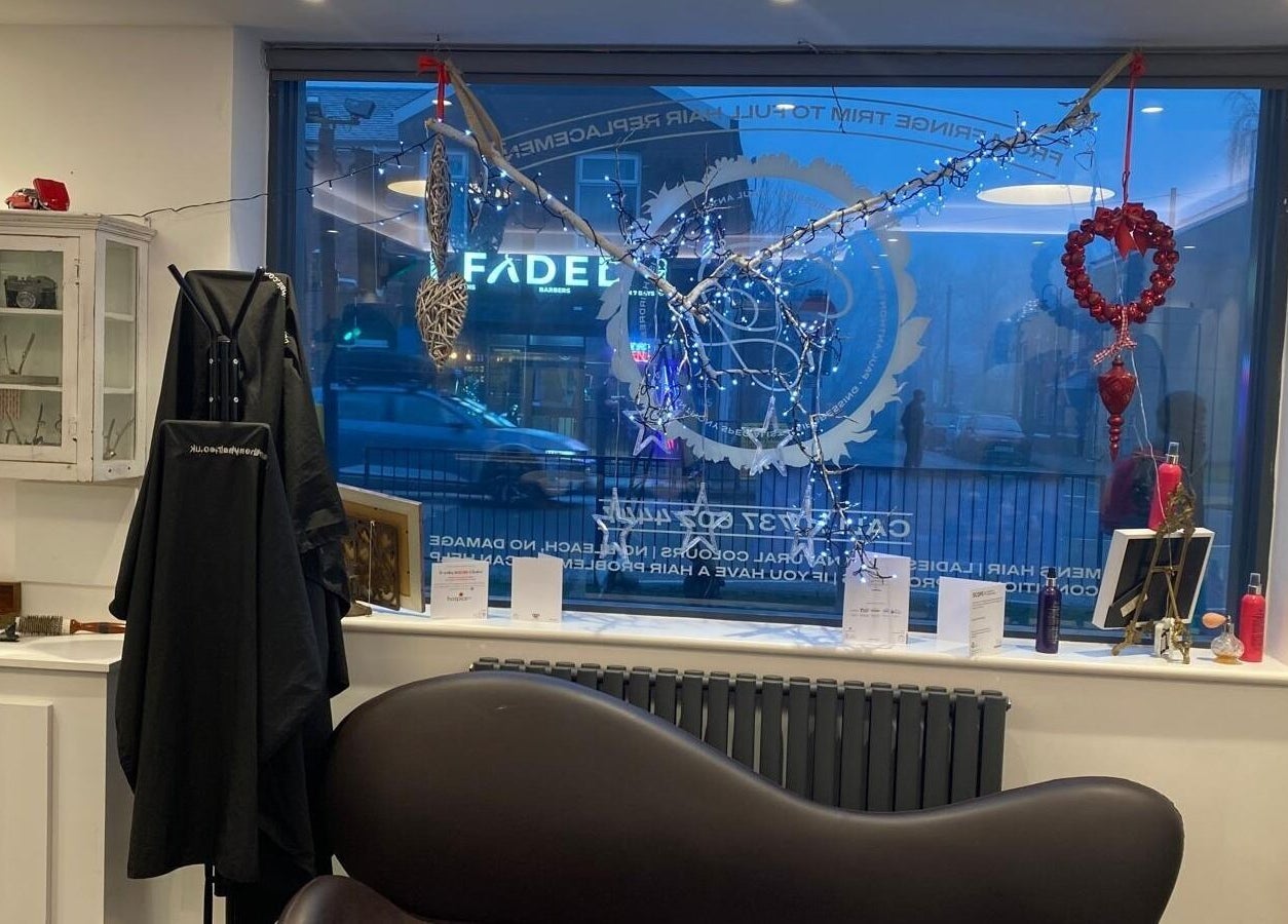 Stylish salon interior at DivaDazzle Hair Extensions, Denton, England, GB with decor and hair styling tools displayed.