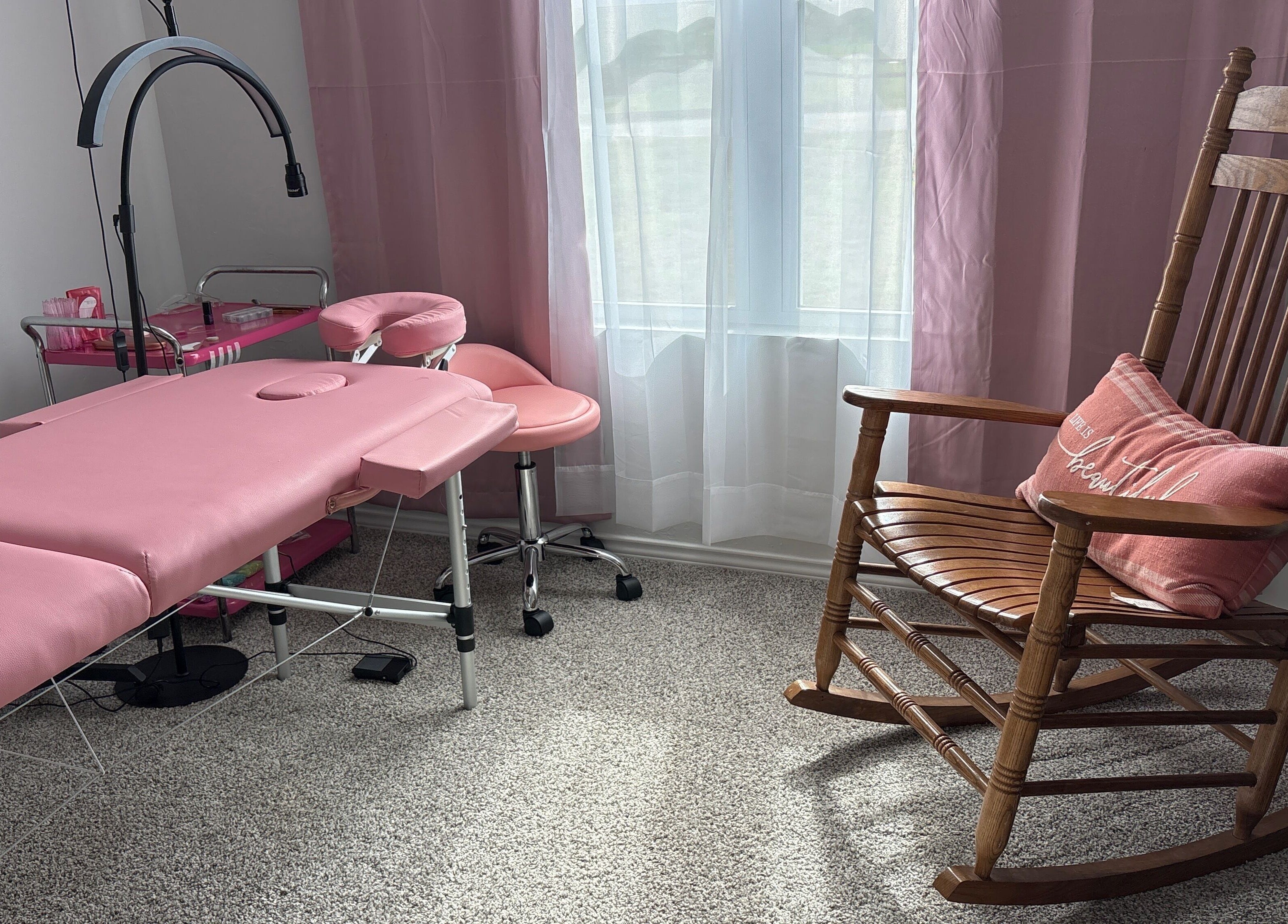 Pink massage bed and rocking chair in Britlyn Begley, Shawnee, Oklahoma, US wellness venue.