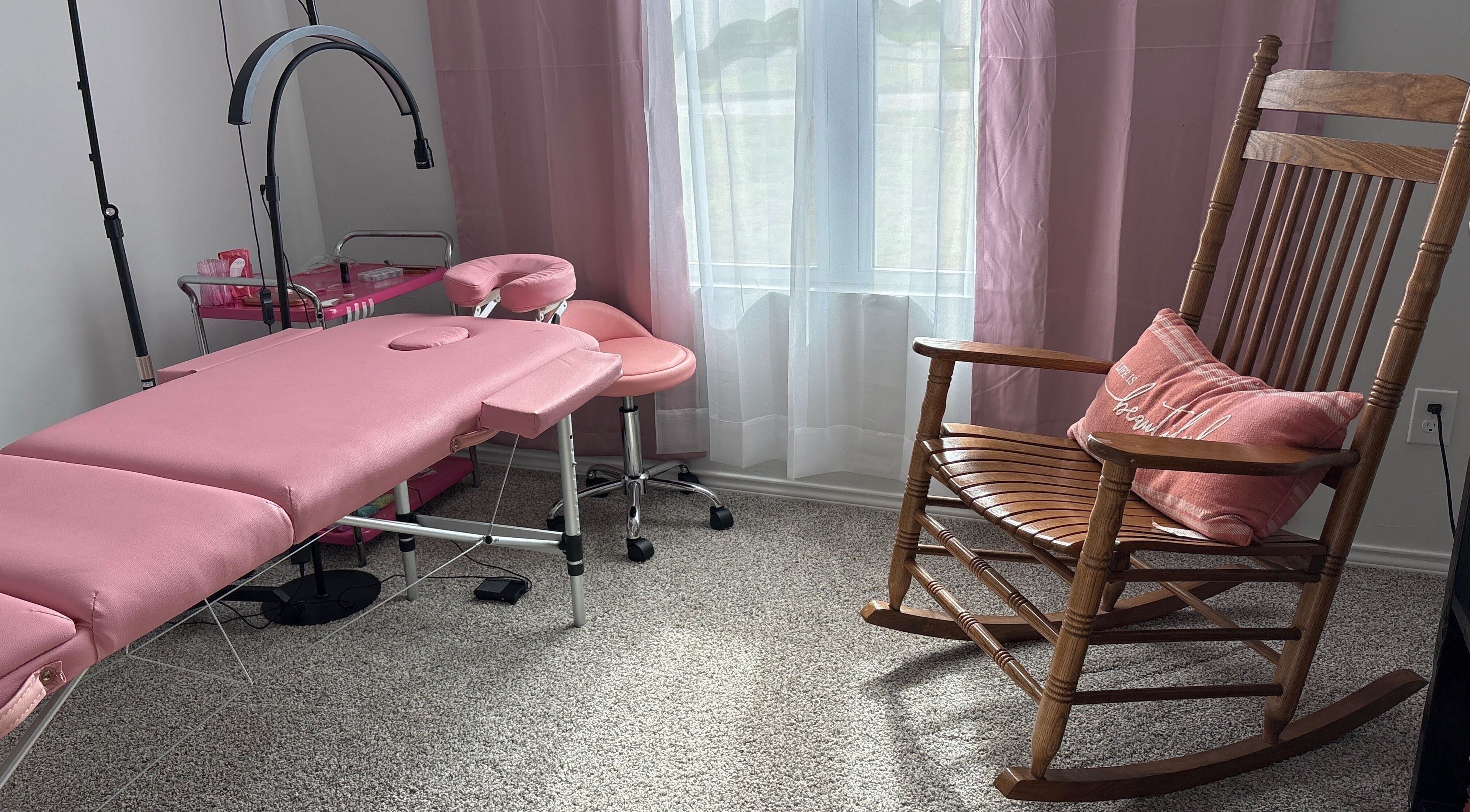 Pink massage bed and rocking chair in Britlyn Begley, Shawnee, Oklahoma, US wellness venue.
