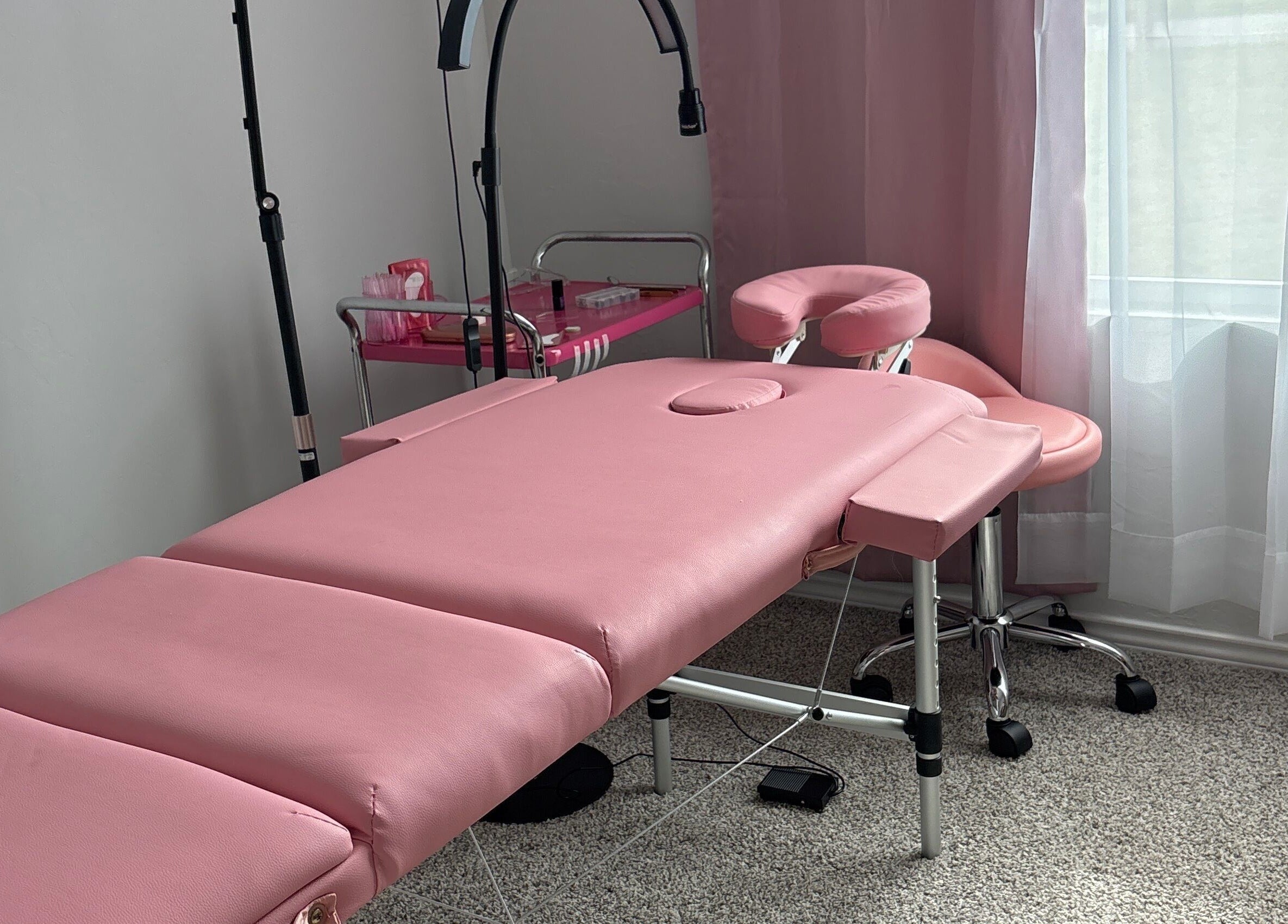 Relaxing pink massage setup at Britlyn Begley in Shawnee, Oklahoma, US with plush table and soft lighting.