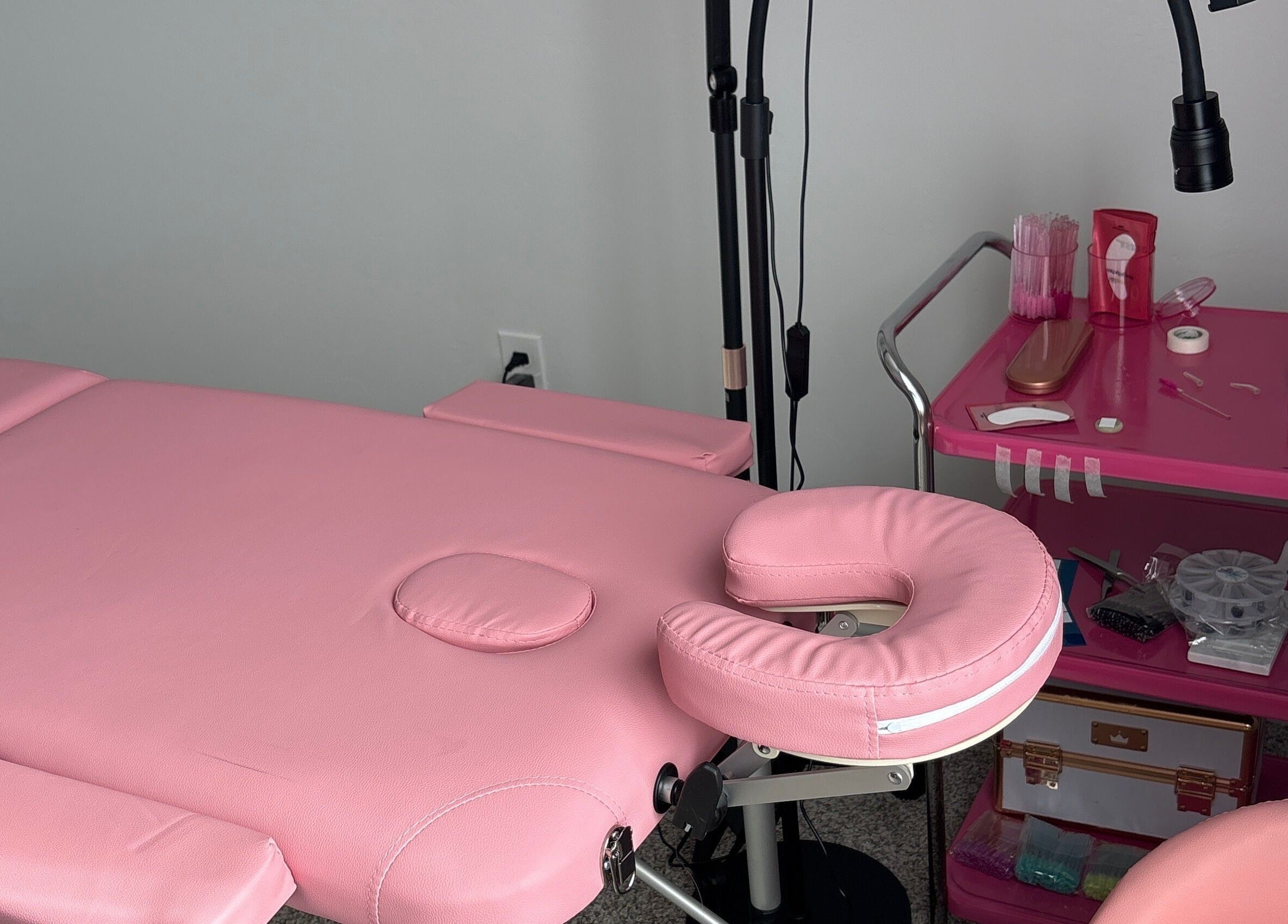 Cozy pink treatment bed at Britlyn Begley, Shawnee, Oklahoma, US, ready for beauty services.