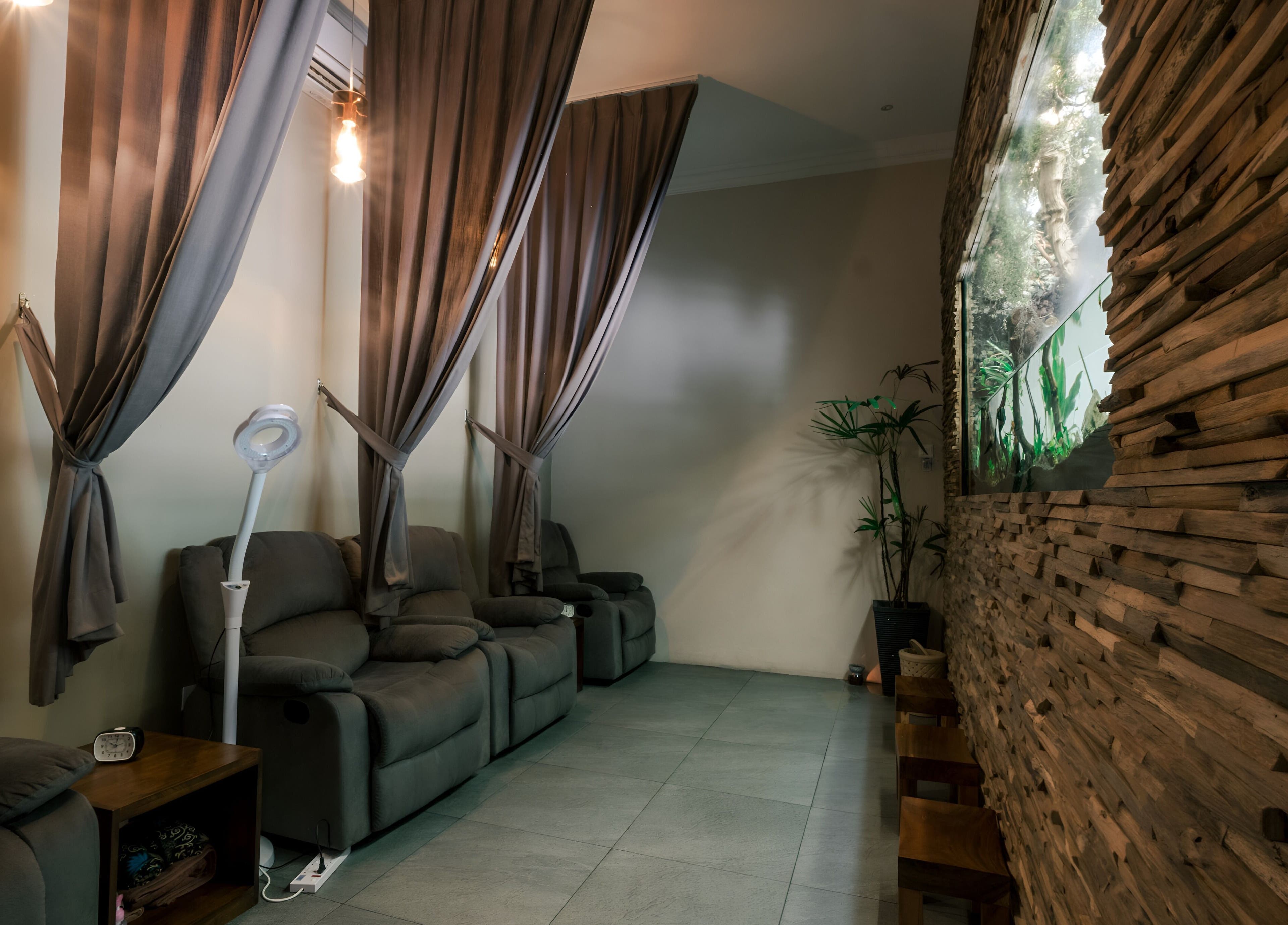 Relaxing lounge area at Spa Central Nagoya, Kepulauan Riau, featuring plush seating and ambient lighting.