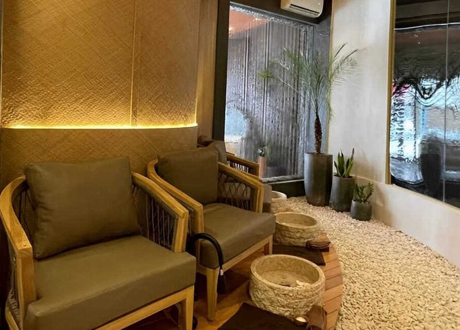 Relaxing seating area at Spa Central Baloi, Kepulauan Riau, with cozy chairs and warm lighting.