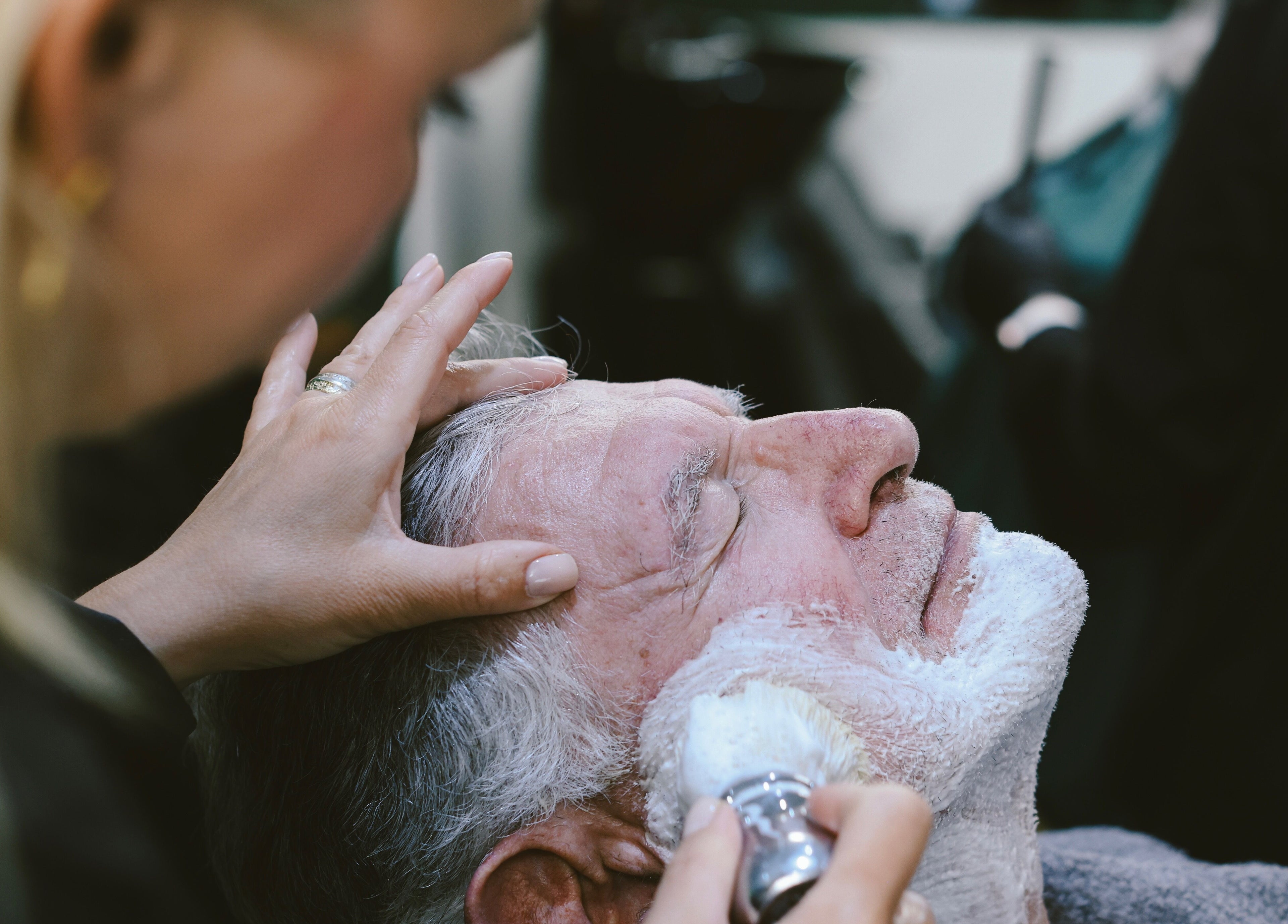 Relaxing shave experience at Hairport in Bushey, England, GB. A client enjoys a professional grooming service.