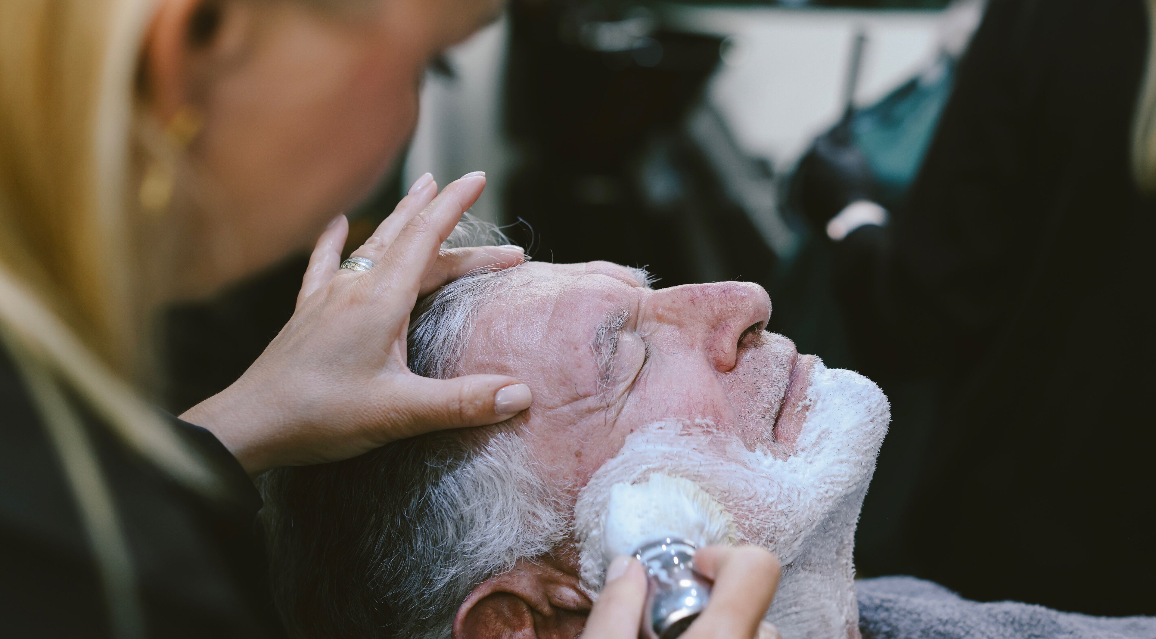 Relaxing shave experience at Hairport in Bushey, England, GB. A client enjoys a professional grooming service.