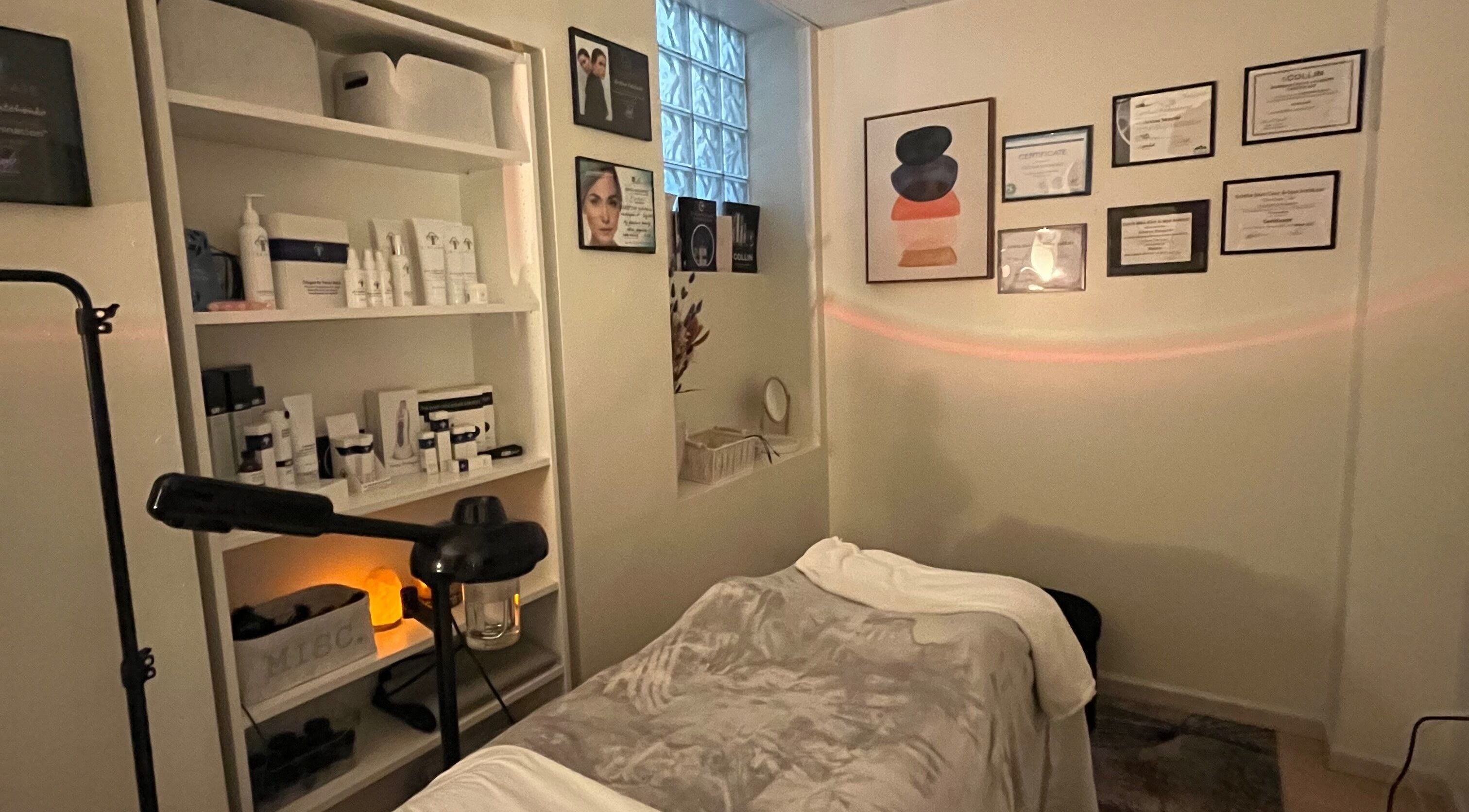 Tranquil treatment room at Esthetician Chicago, Chicago, Illinois, US with skincare products and certificates.