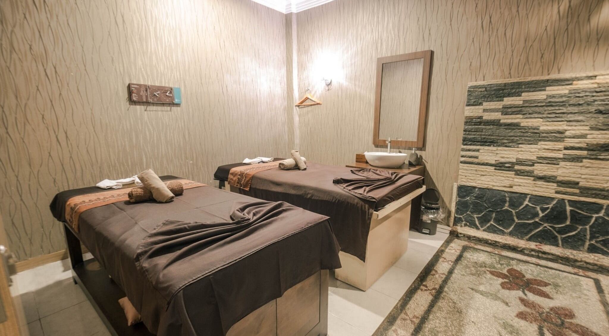 Elegant massage room with two tables at Massage Central, Kepulauan Riau, Kepulauan Riau, ID, offering tranquility.