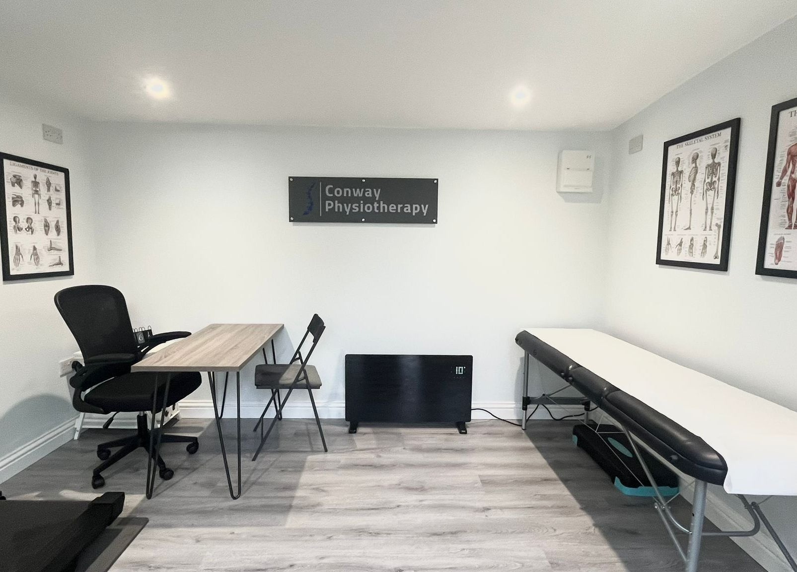 Interior of Conway Physiotherapy in Ratby, England, GB featuring a therapy table and anatomical posters.