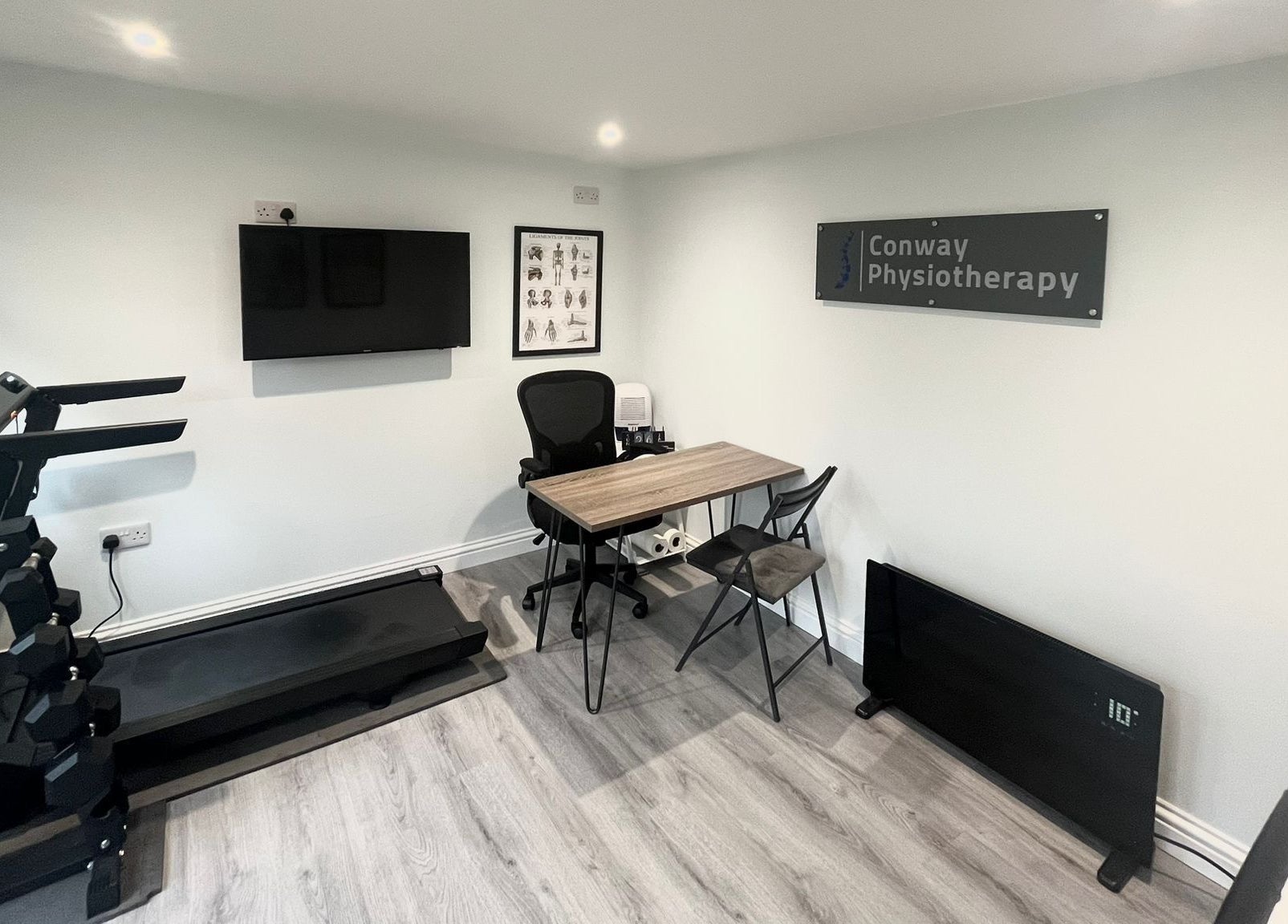 Conway Physiotherapy in Ratby, England, GB: modern therapy room with treadmill, desk, and health posters.