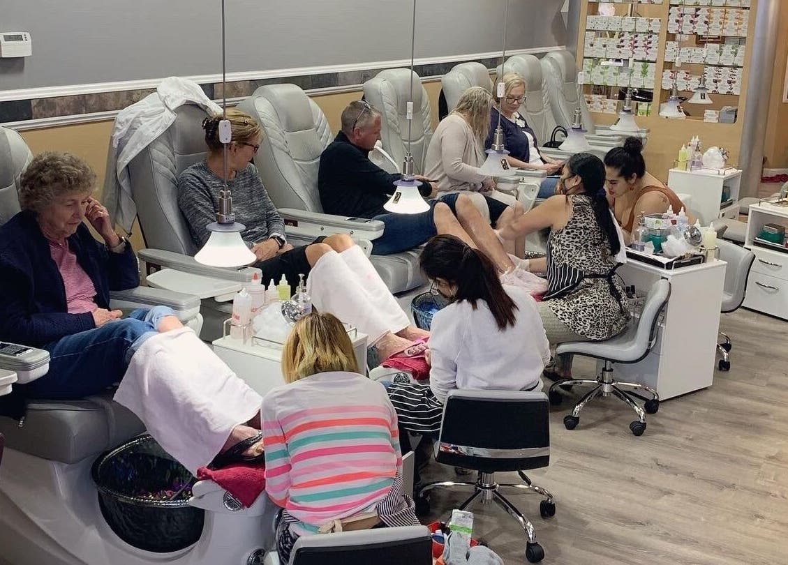 Clients enjoying pedicures at Eden of Ashburn Salon and Spa, Ashburn, Virginia, US. Relaxing spa atmosphere.