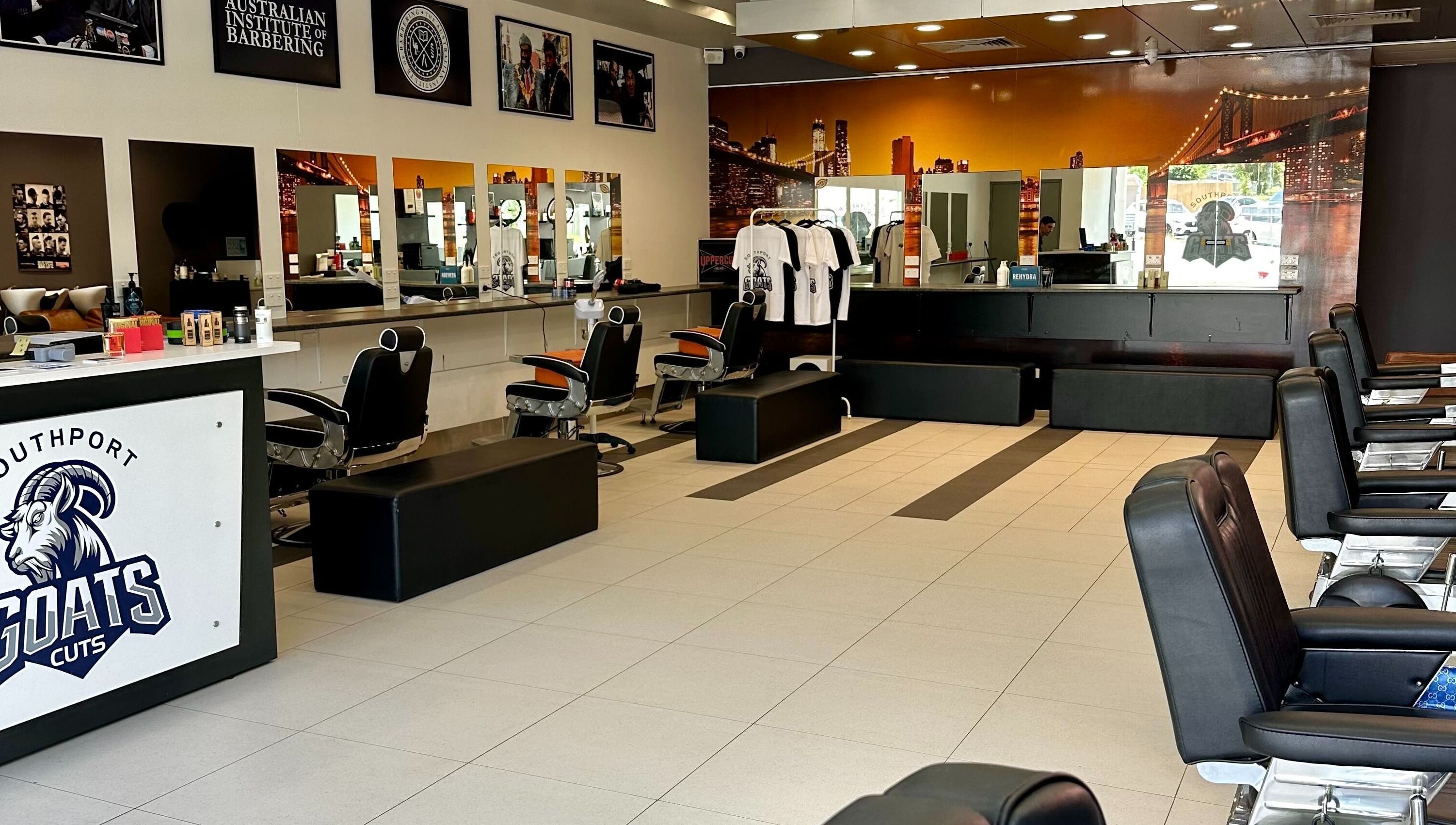 Interior of Goats Cuts barber shop in Southport, Queensland, AU with stylish chairs and sleek decor.