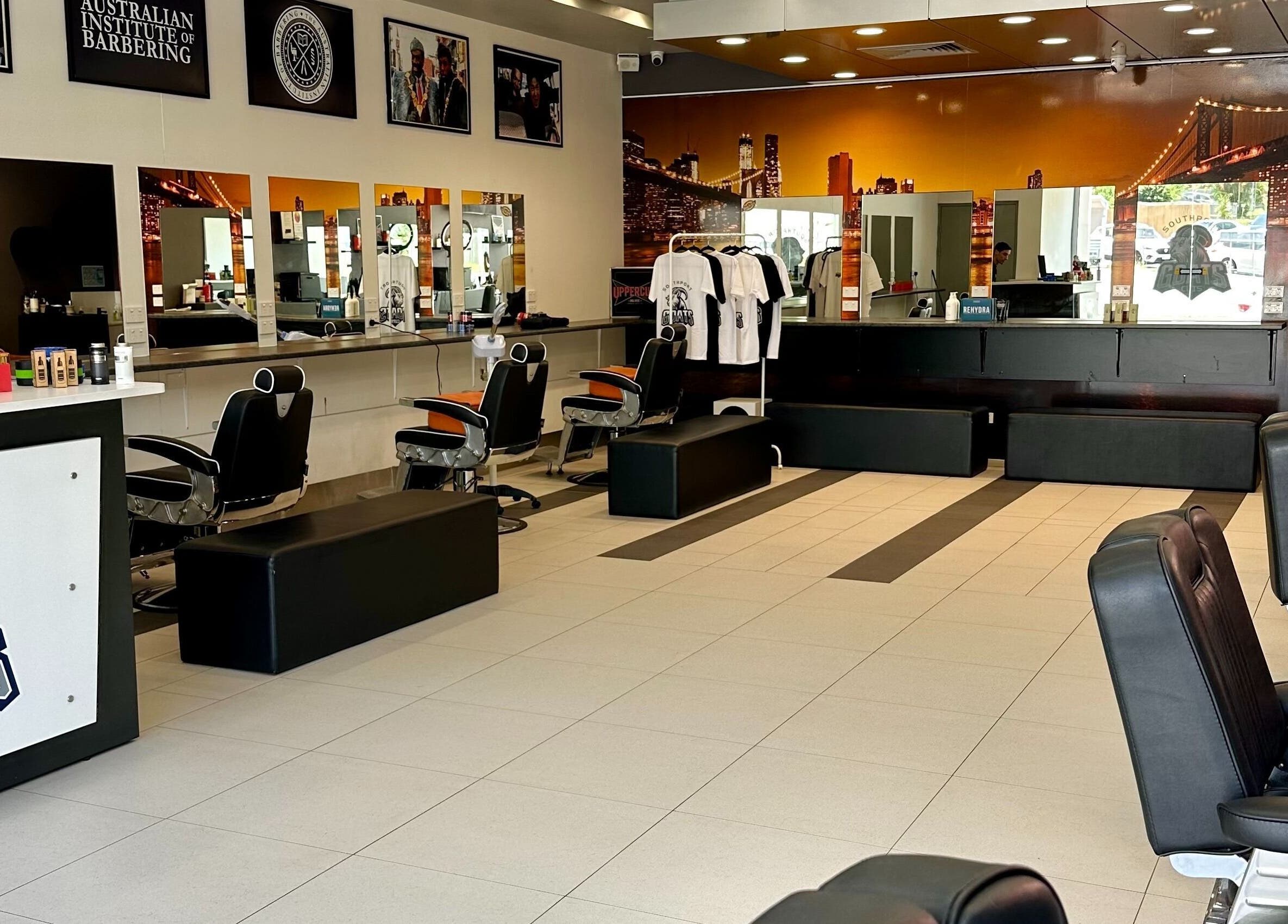 Interior of Goats Cuts barber shop in Southport, Queensland, AU with stylish chairs and sleek decor.