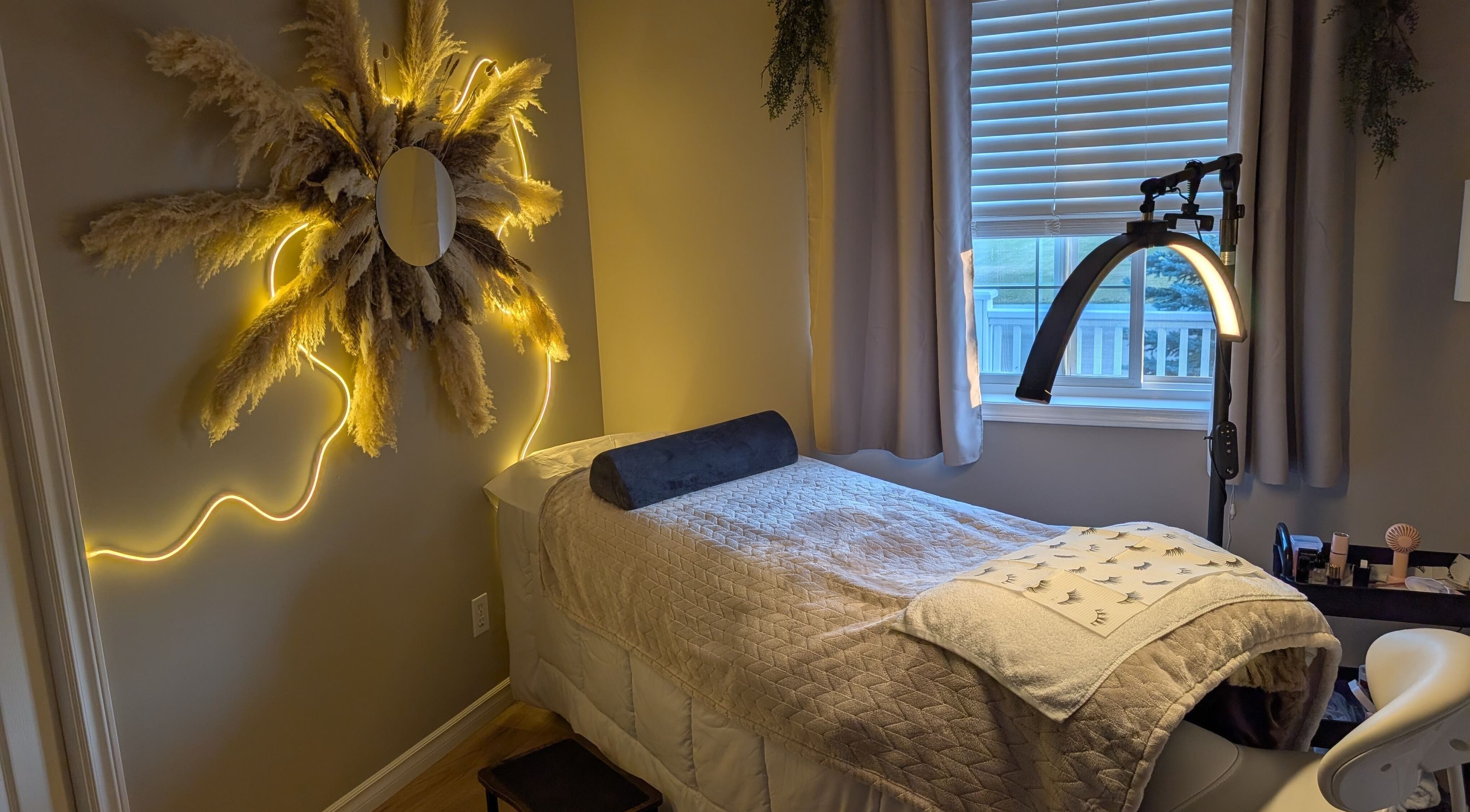 Relaxing spa room at Country Lashes in Warburg, Alberta, CA with cozy bed and elegant light decor.