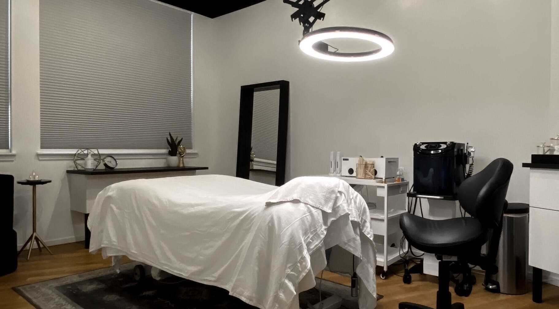 Luxurious treatment room at Esthetic Society, Bellevue, Washington, US with a cozy bed and elegant decor.