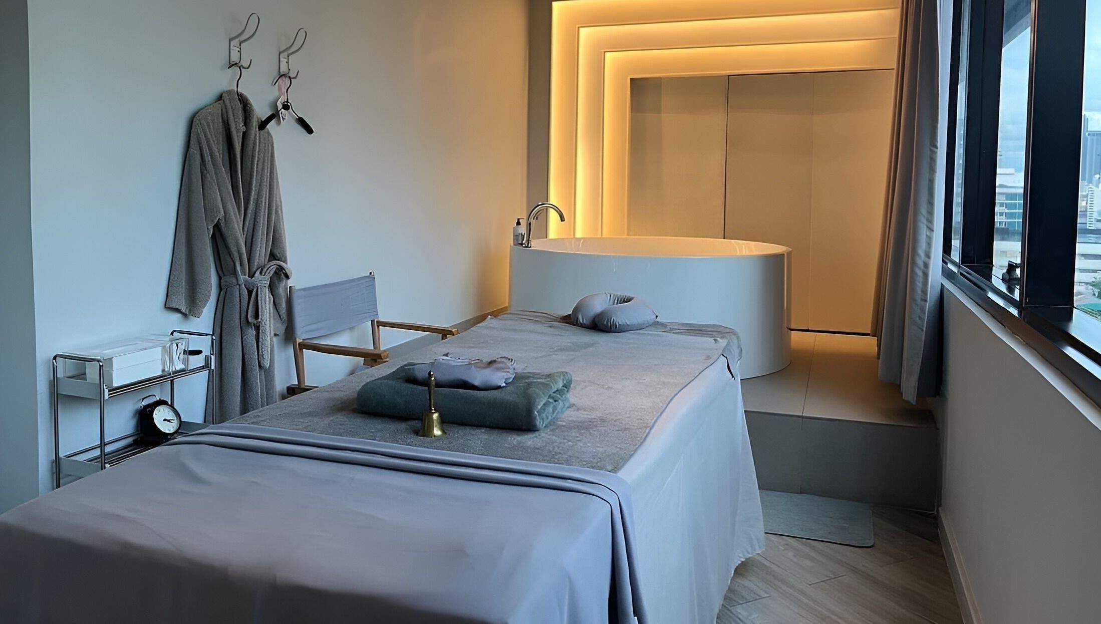 Elegant treatment room at XINGSPA, กรุงเทพมหานคร, TH, featuring a luxurious massage table and ambient lighting.