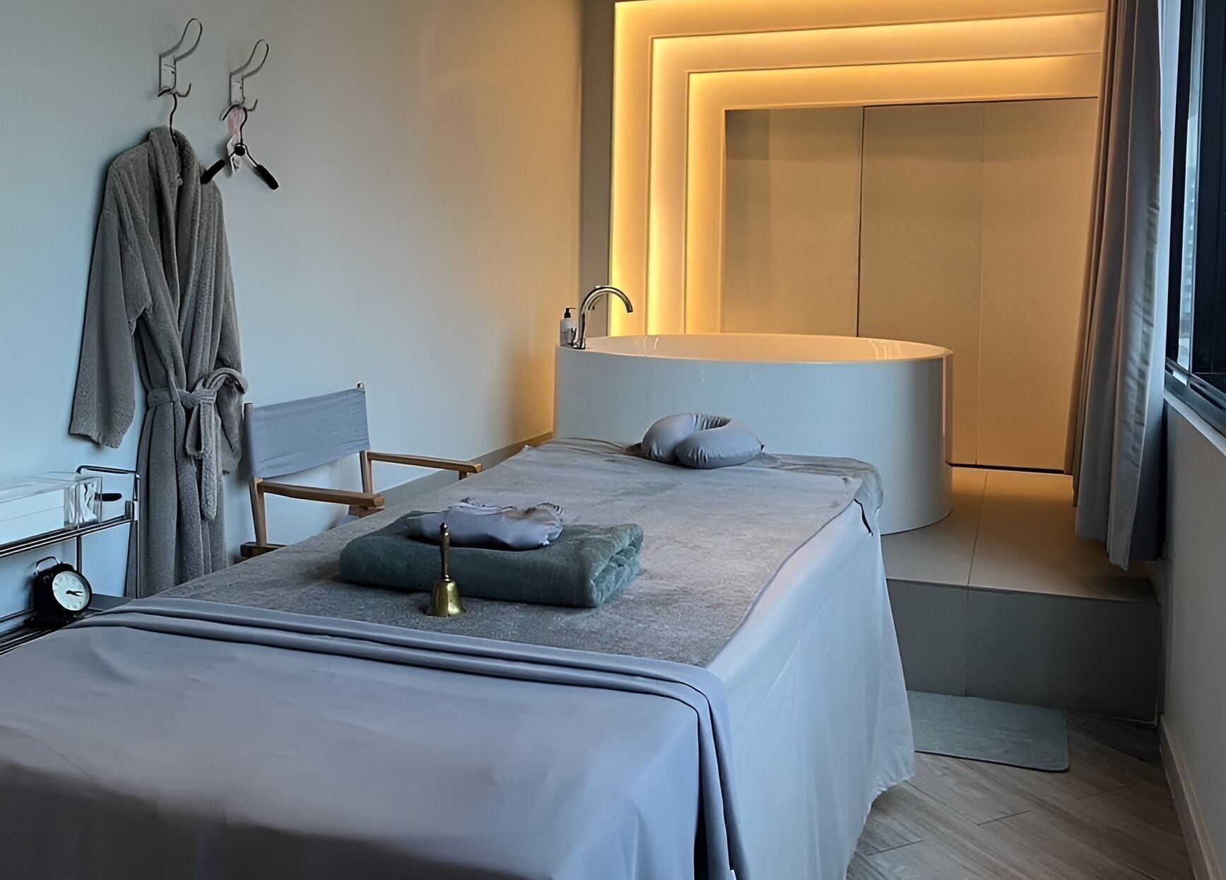 Elegant treatment room at XINGSPA, กรุงเทพมหานคร, TH, featuring a luxurious massage table and ambient lighting.