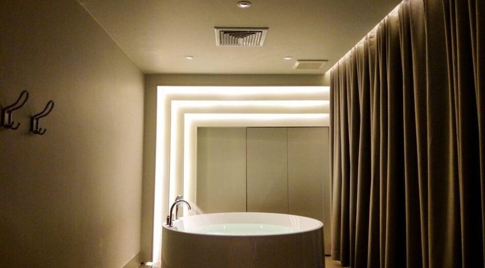 Luxurious round bathtub at XINGSPA, กรุงเทพมหานคร. Relax in style at our premier wellness venue.