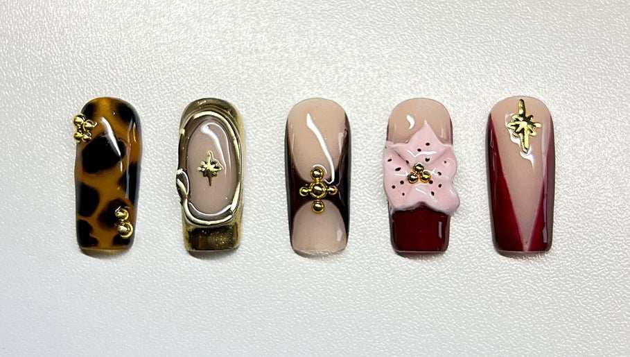 Intricate nail art at Sweet&SinfulBeauty, Tamworth, New South Wales, AU, showcasing elegant designs and embellishments.