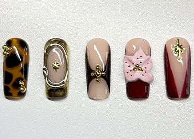 Intricate nail art at Sweet&SinfulBeauty, Tamworth, New South Wales, AU, showcasing elegant designs and embellishments.