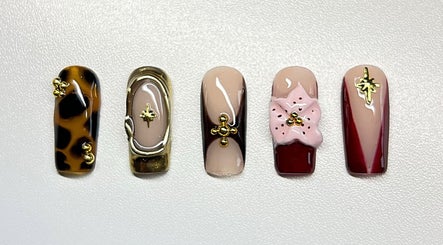 Intricate nail art at Sweet&SinfulBeauty, Tamworth, New South Wales, AU, showcasing elegant designs and embellishments.