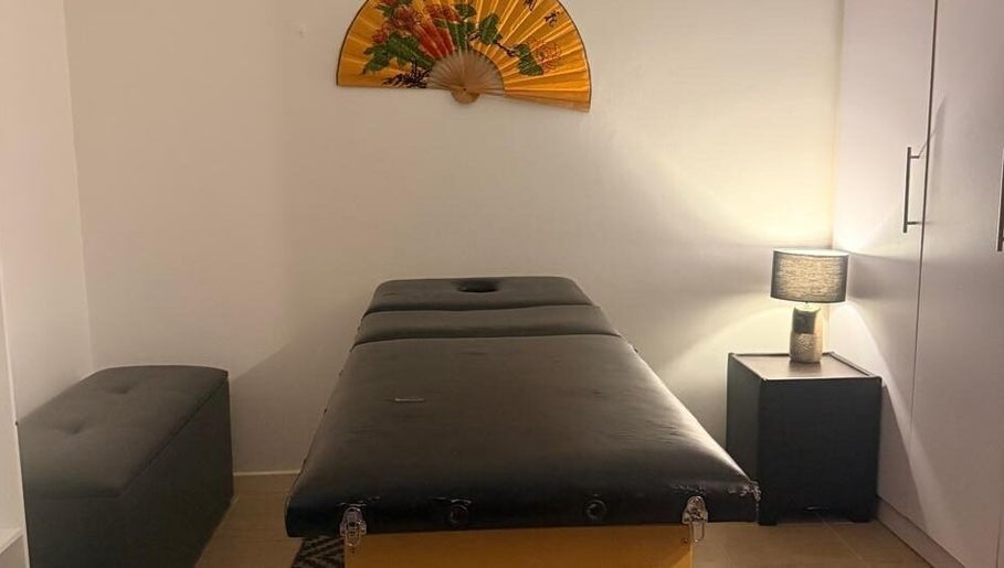 Relaxing massage room at Statera Massage Studio, Cape Town, Western Cape, ZA, featuring a cozy ambiance.