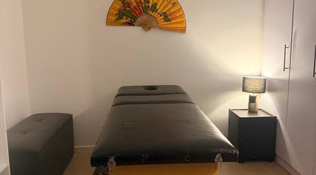 Relaxing massage room at Statera Massage Studio, Cape Town, Western Cape, ZA, featuring a cozy ambiance.