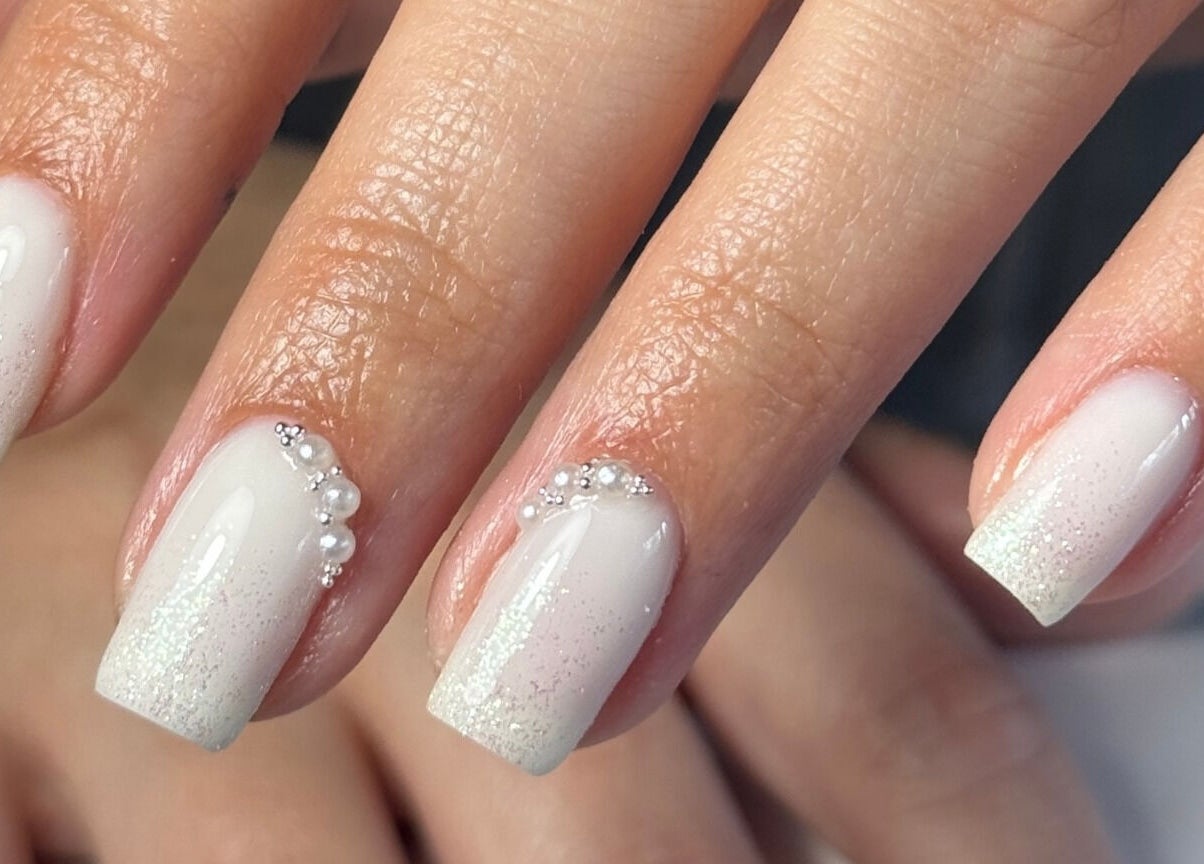 Elegant pearl nail art at Ameliaelizabethnails in Stoke-on-Trent, England, GB with shimmering accents.