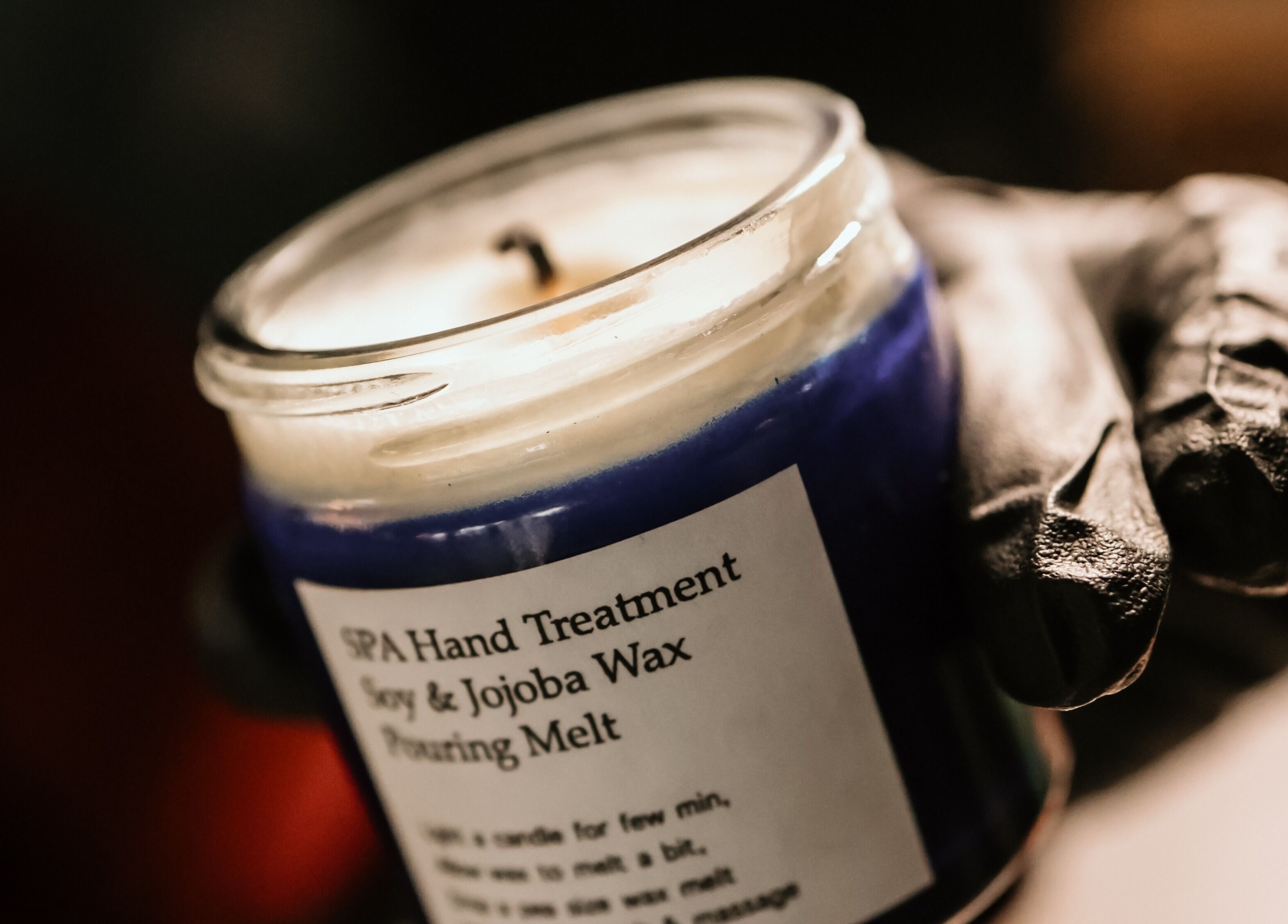 Hand holding a soy and jojoba wax candle at Zencora, Drogheda, County Louth, IE.