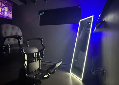 Elegant salon chair and illuminated mirror at Estebanz, Laval, Québec, CA.