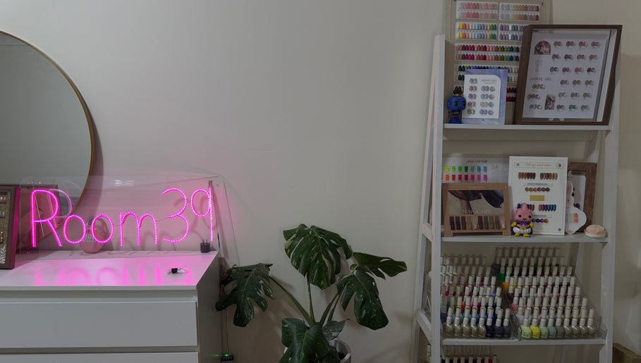 Nails.Room39's chic interior in Green Valley, New South Wales, AU featuring a neon sign and nail color display.
