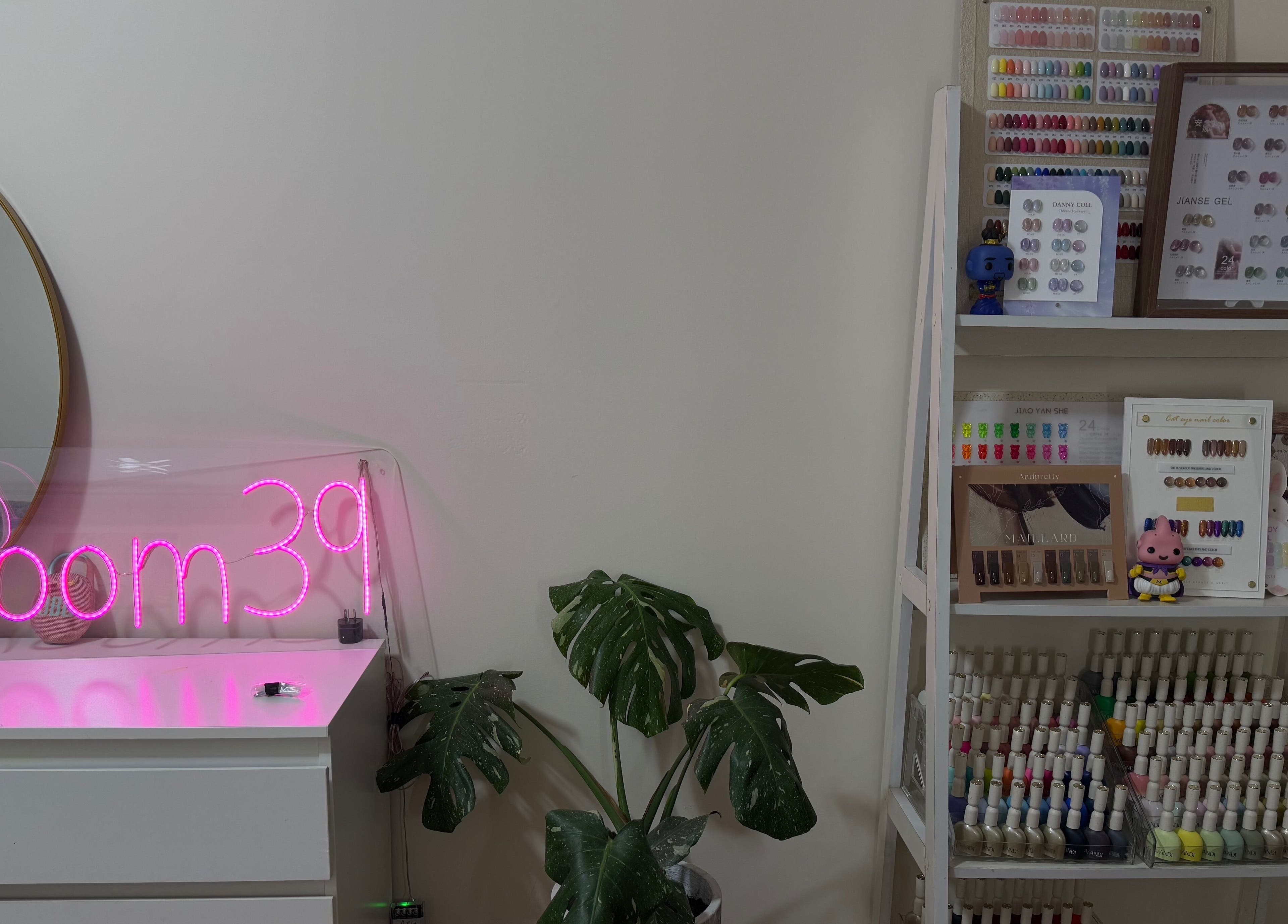 Nails.Room39's chic interior in Green Valley, New South Wales, AU featuring a neon sign and nail color display.