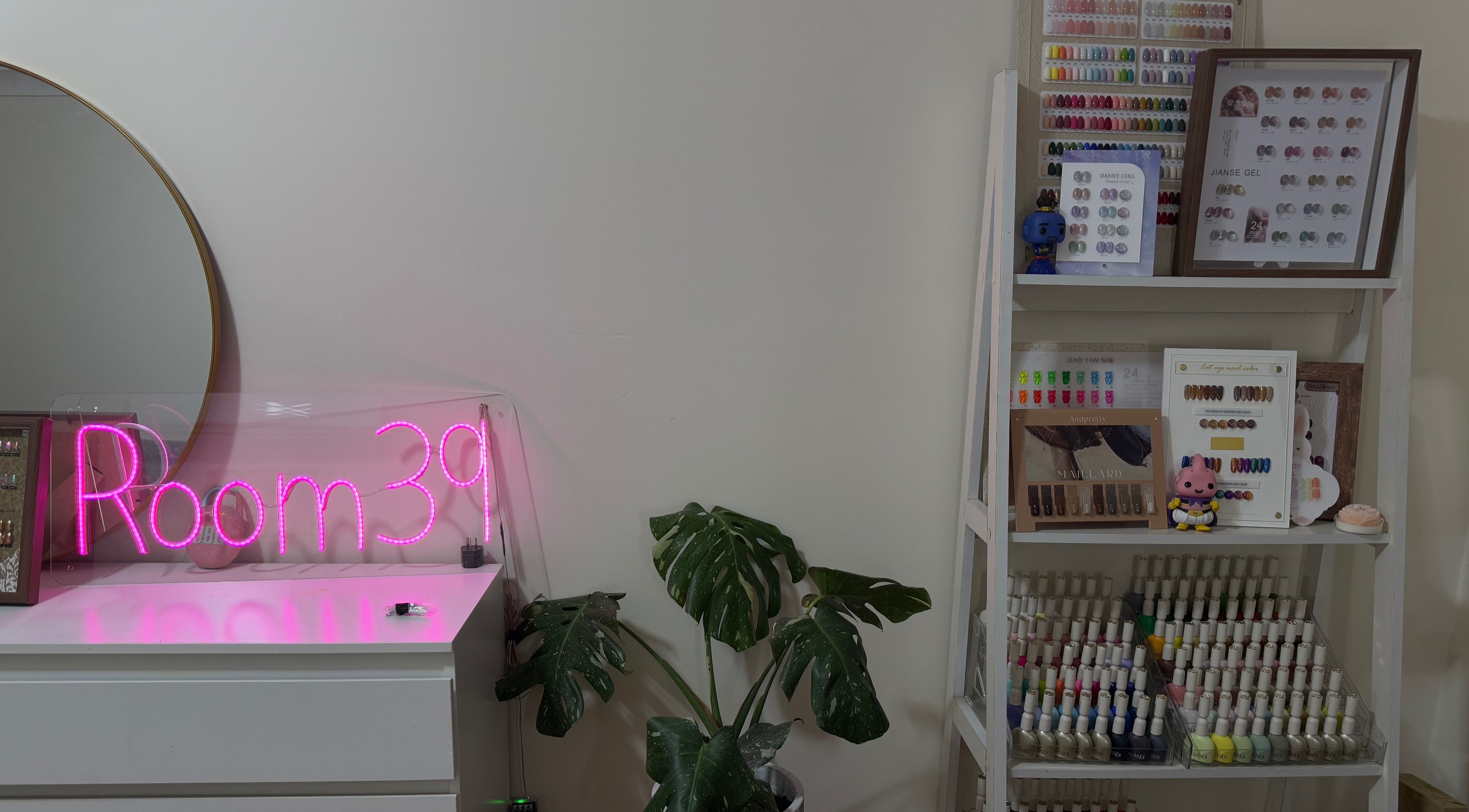 Nails.Room39's chic interior in Green Valley, New South Wales, AU featuring a neon sign and nail color display.