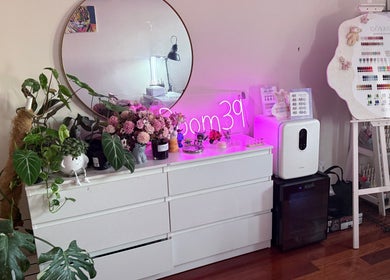 Elegant nail setup at Nails.Room39, Green Valley, NSW, AU with neon sign and decor.