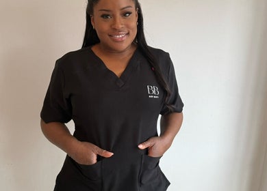 Beauty professional at Bare Bliss Beauty, Thornton Heath, England, GB, wearing branded uniform.