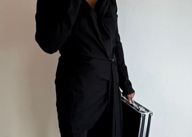 Person in stylish black attire holding a sleek case at Bare Bliss Beauty, Thornton Heath, England, GB.