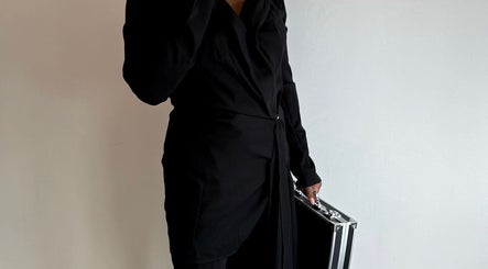 Person in stylish black attire holding a sleek case at Bare Bliss Beauty, Thornton Heath, England, GB.