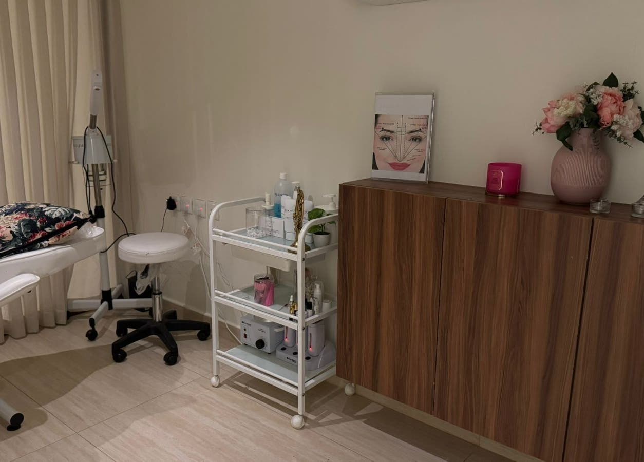 Treatment room at Rosoleen Beauty&Spa صالون روزولين, Riyadh, featuring a floral pillow and skincare essentials.