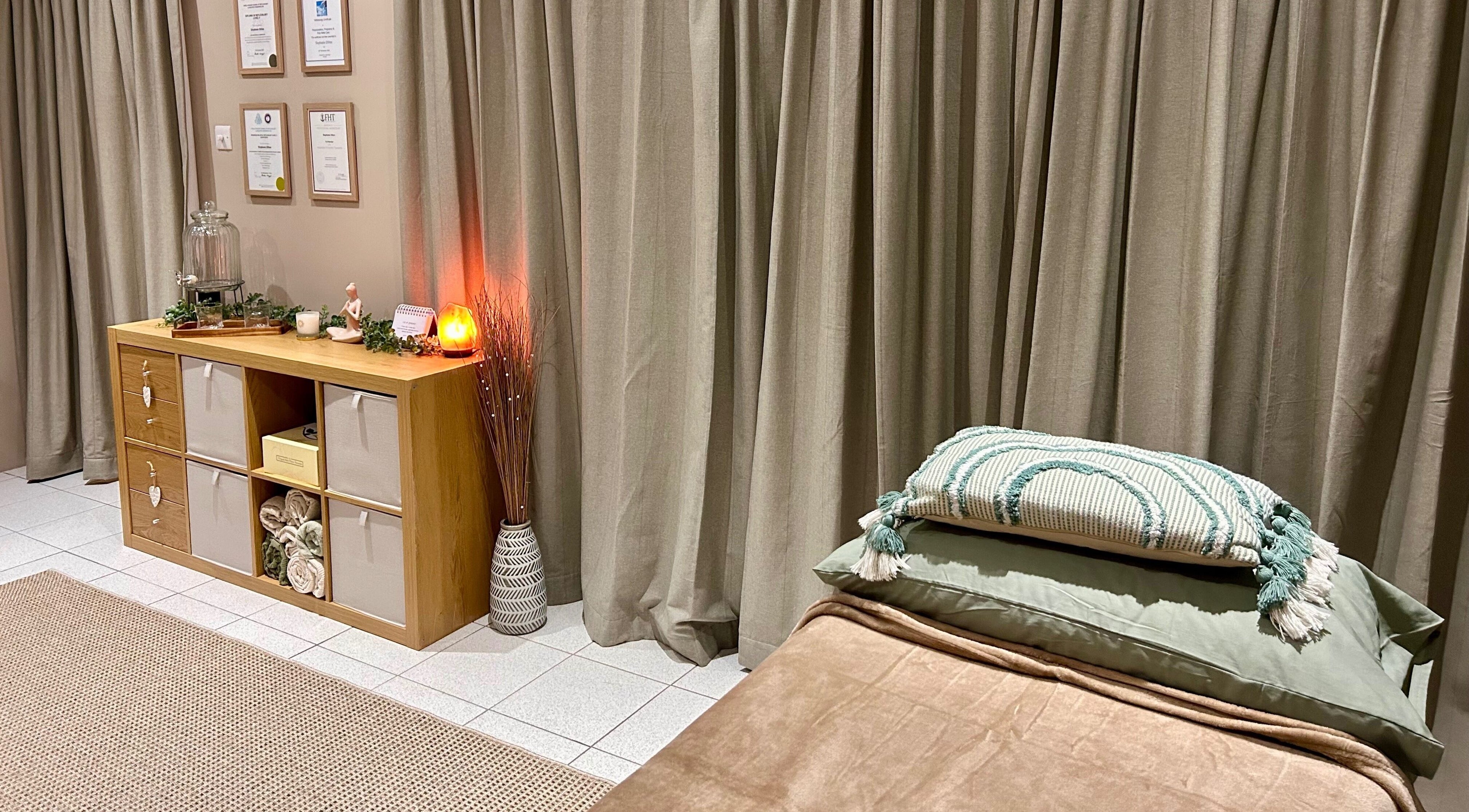 Tranquil massage room at Relax & Bloom, Bangor, Northern Ireland, GB, featuring soft lighting and elegant decor.