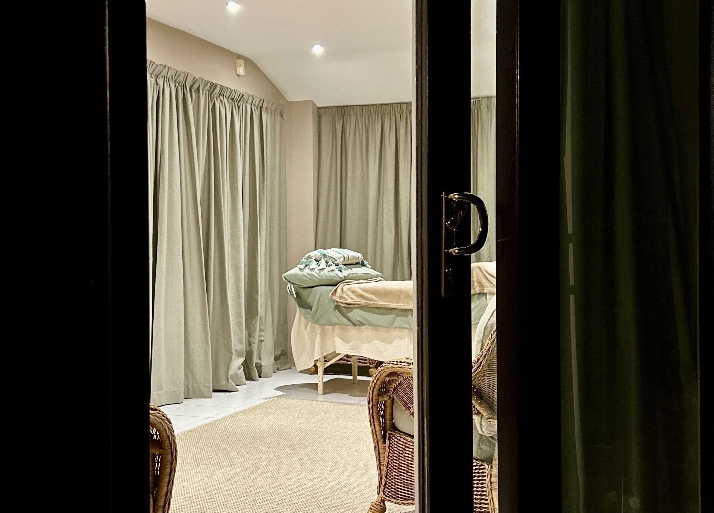 Elegant massage room at Relax & Bloom, Bangor, Northern Ireland, GB with soothing decor and gentle lighting.