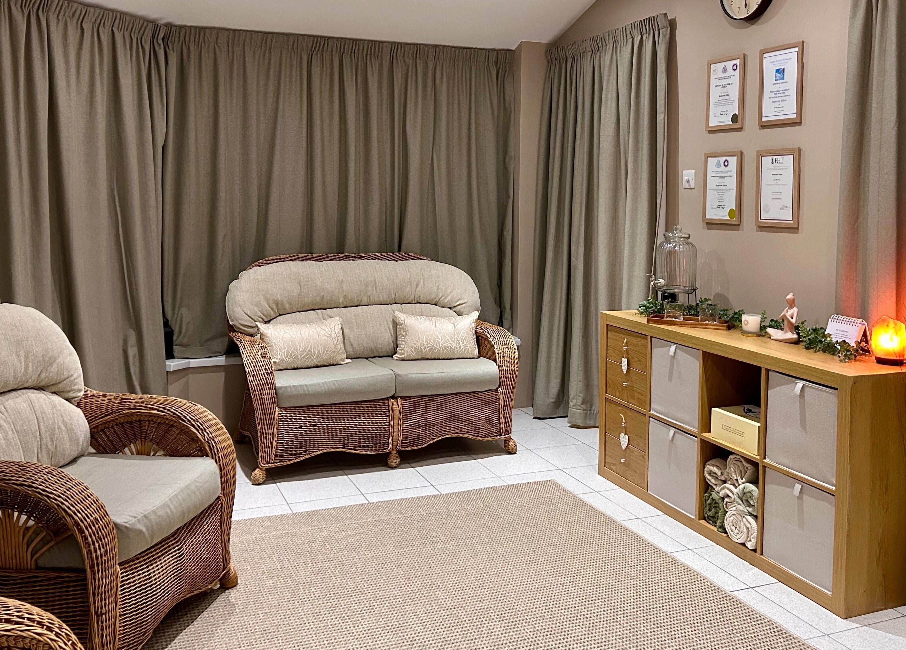 Elegant lounge at Relax & Bloom in Bangor, Northern Ireland, GB, featuring wicker seating and warm lighting.