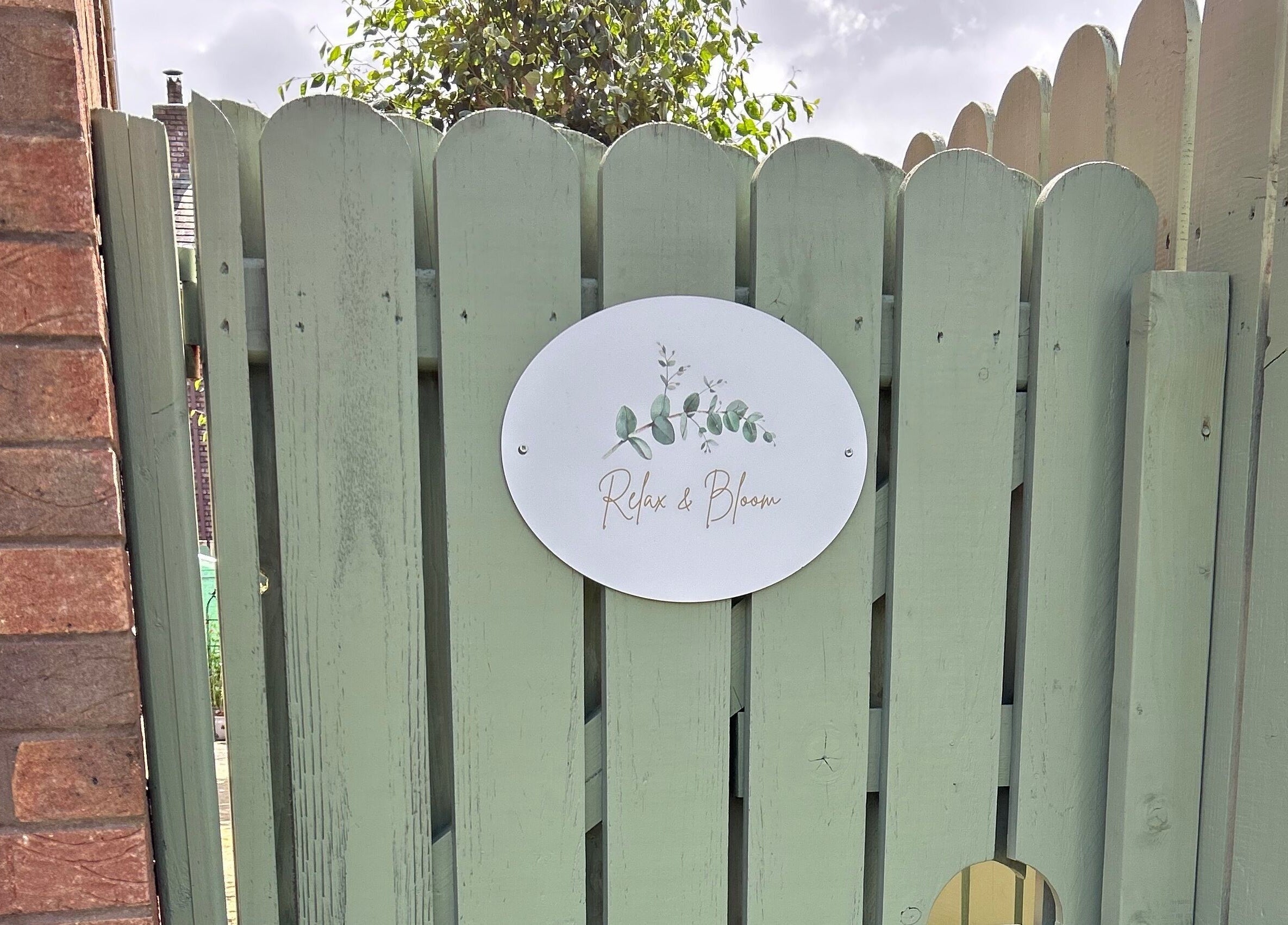 Entrance gate to Relax & Bloom in Bangor, Northern Ireland, GB, featuring a serene garden sign.