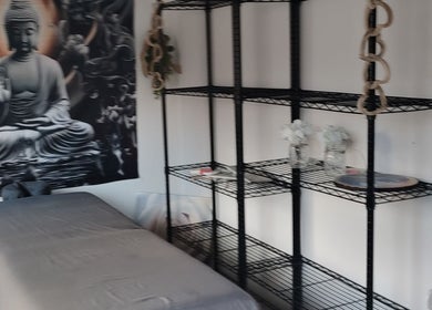 Relaxing massage room at Above & beyond beauty & massage, Sutton-in-ashfield, England, GB, featuring Buddha decor.