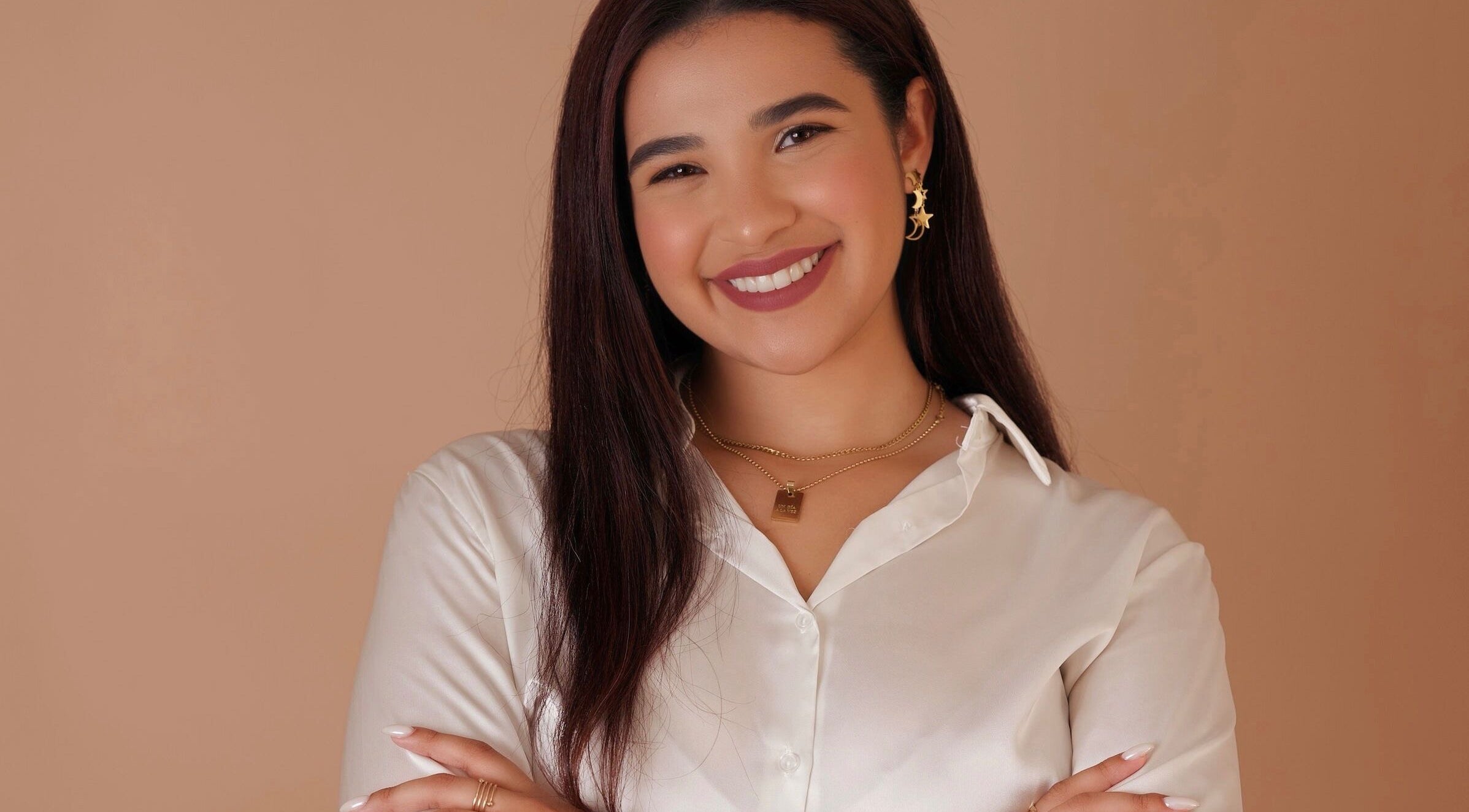 Professional smiling warmly at Celestial Nails✨, Carolina, PR welcoming clients with elegance.