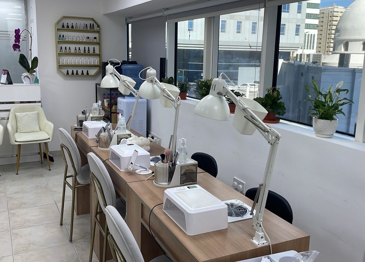 Bright interior of Hype Nails Beauty Salon, Abu Dhabi, AE, showcasing nail stations with elegant decor.